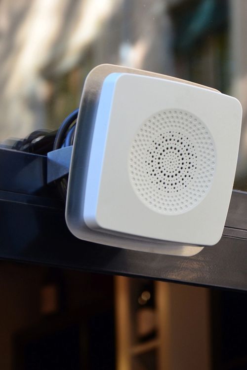 A white audio beacon at an entrance