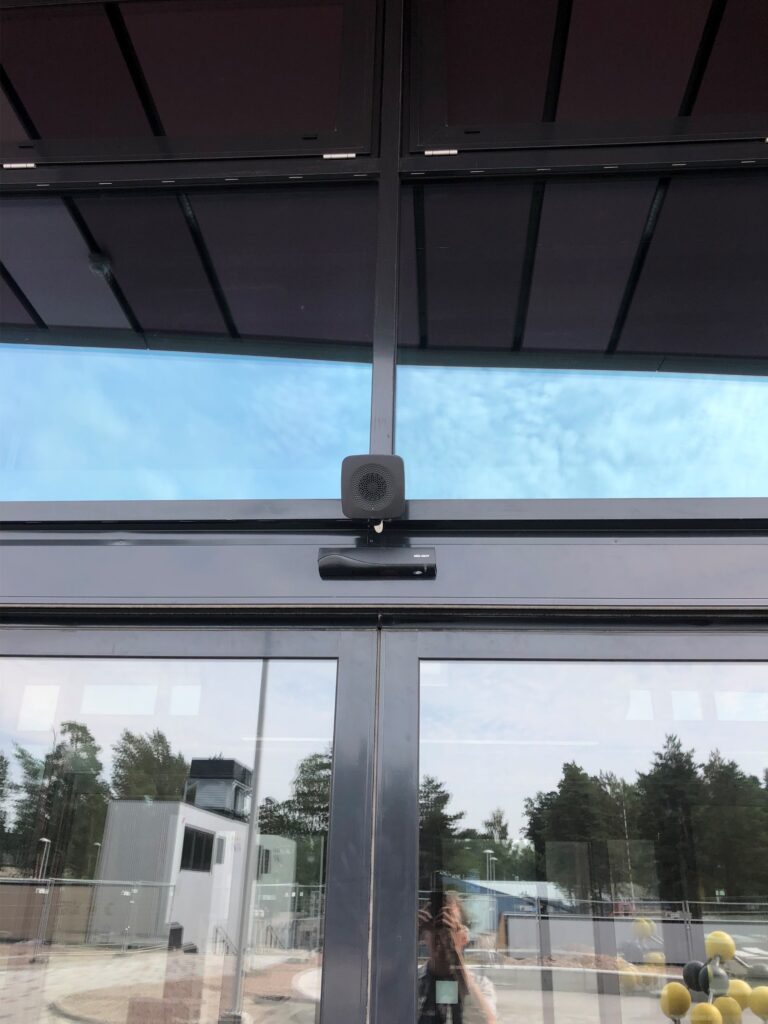 A black audio beacon at an entrance